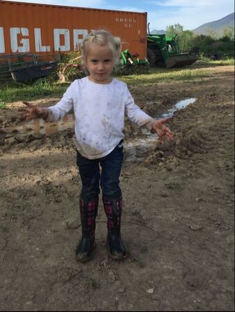 Little girl after playing in the farm mud