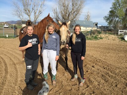 Girls in pjs with their horses 
