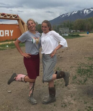 Girls in skirts and muck boots caring for animals